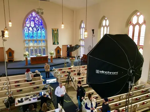 A large photographic softbox set up inside a church.