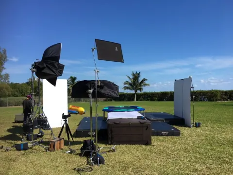 Lighting panels and equipment arranged on a lawn under blue skies.