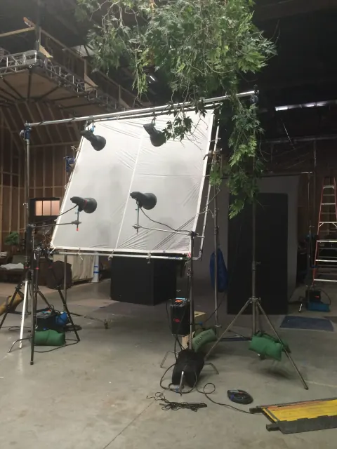 Lighting and diffusion equipment set up beside a house entrance.