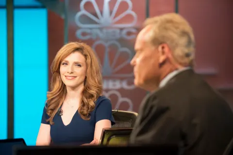 A woman and man seated in a studio with CNBC branding.
