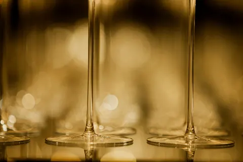 Close-up of the stems and bases of wine glasses.