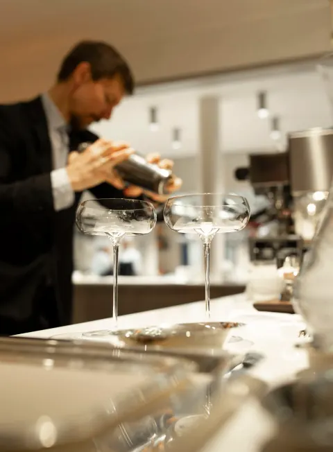 A chef concentrating on food preparation at a kitchen counter.
