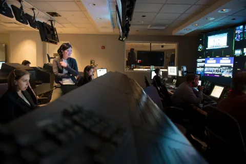 A television production team working in a control room.